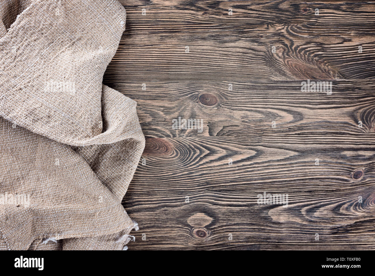 Linen napkin on a wooden table. View top. Background Stock Photo