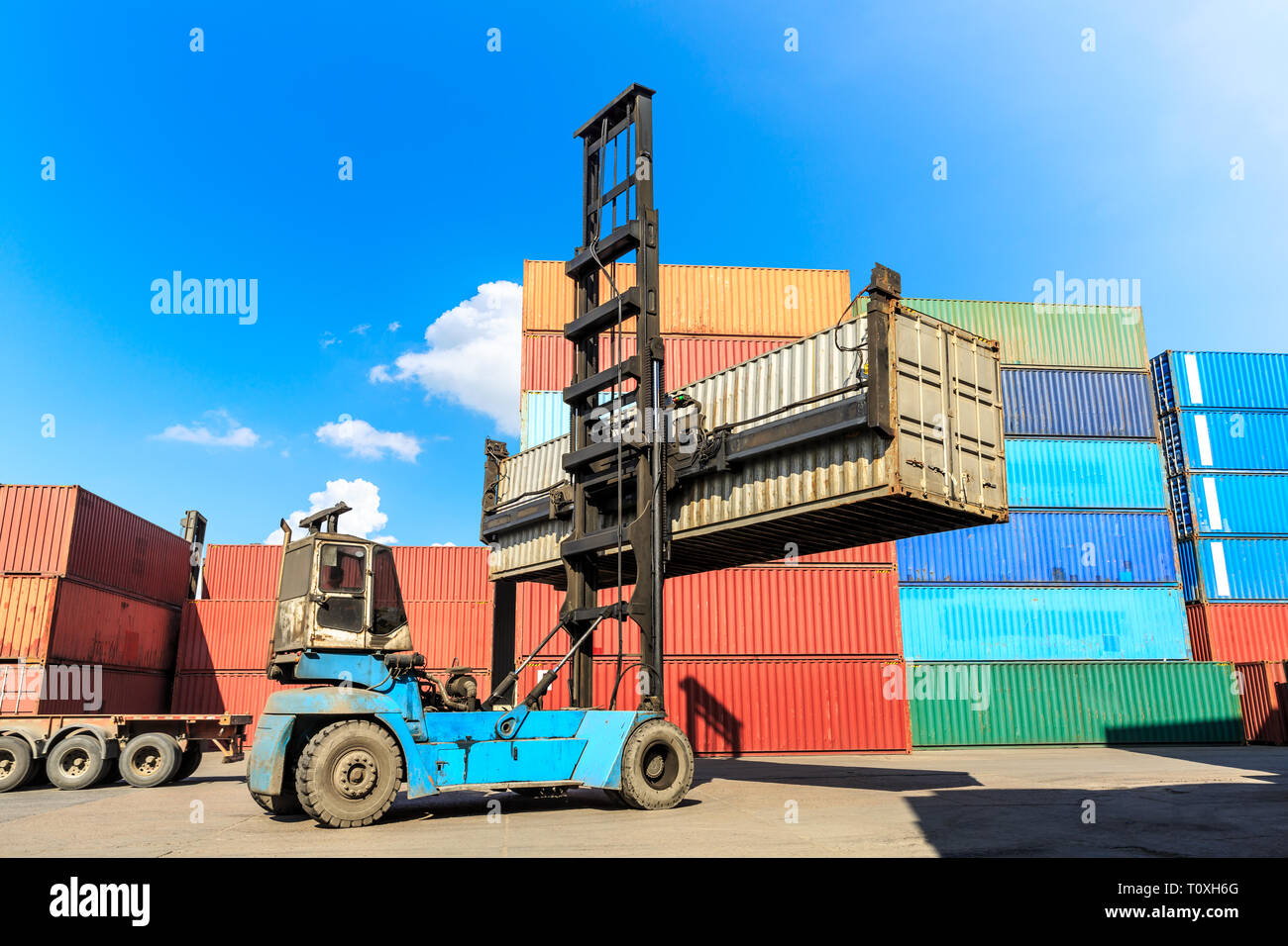 Forklift container loading and unloading cargo into the import-export zone Stock Photo
