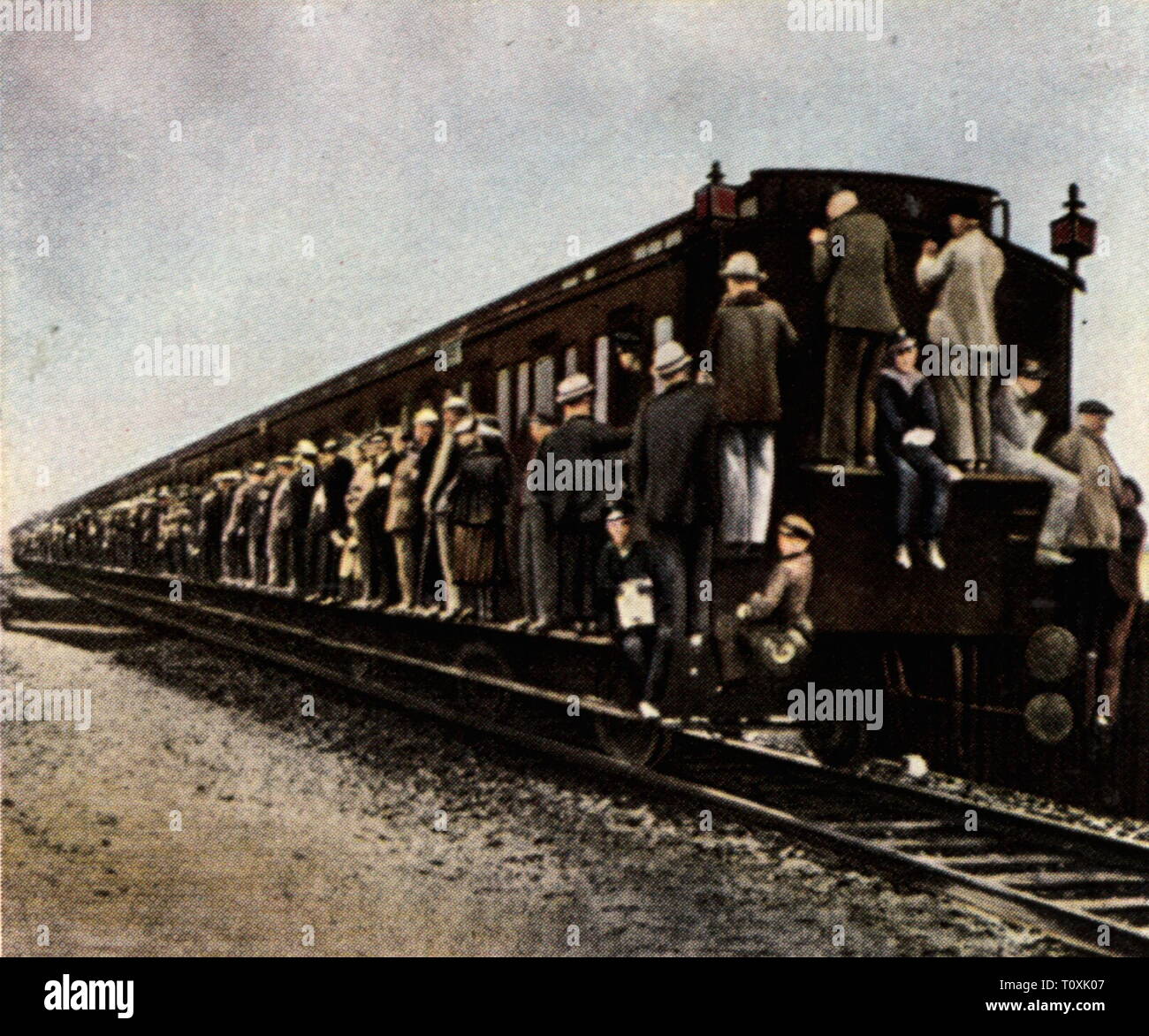 strike of the railroad employees, 1.2. - 7.2.1922, overcrowded passenger train, coloured photograph, cigarette card, series 'Die Nachkriegszeit', 1935, Deutsche Reichsbahn, railway, railroad, railways, railroads, passengers, passenger, congestion, overcrowd, overcrowding, train, trains, economy, people, Germany, German Reich, Third Reich, Weimar Republic, 1920s, 20th century, strike, strikes, coloured, colored, post war period, post-war period, post-war years, post-war era, historic, historical, railroader strike, Additional-Rights-Clearance-Info-Not-Available Stock Photo