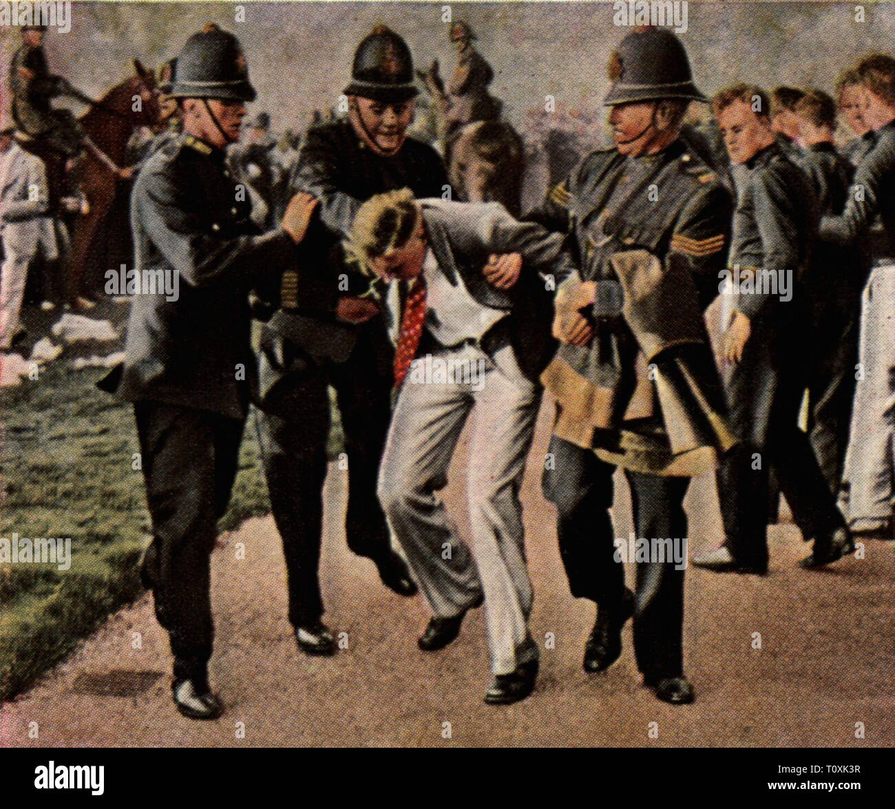 politics, demonstrations, Great Britain, protest of the unemployed, police is detaining a demonstratorsin Hdye Park, London, 10.9.1931, coloured photograph, cigarette card, series 'Die Nachkriegszeit', 1935, policemen, policeman, worker, workers, arrest, arresting, unemployment, world depression, world depressions, violence, United Kingdom, 20th century, 1930s, politics, policy, demonstrations, demos, demonstration, demo, protest, protests, unemployed, nonworker, workless, unemployed people, detain, detaining, demonstrators, demonstrator, coloure, Additional-Rights-Clearance-Info-Not-Available Stock Photo