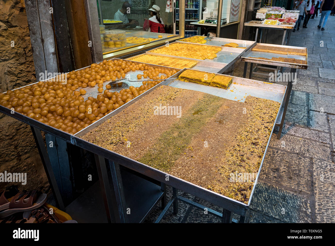 Close up of stalls with sweet fruits and pastry exposed for sale near some street food cafe in Jerusalem. Jerusalem, Israel, 24 October 2018 Stock Photo