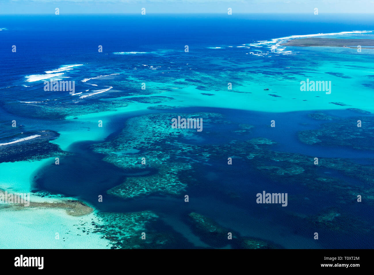 Aerial view of reef and surf in the Wallabi group of the Houtman Abrolhos. (Note: these images are not shot through glass, the plane door is off).  Th Stock Photo
