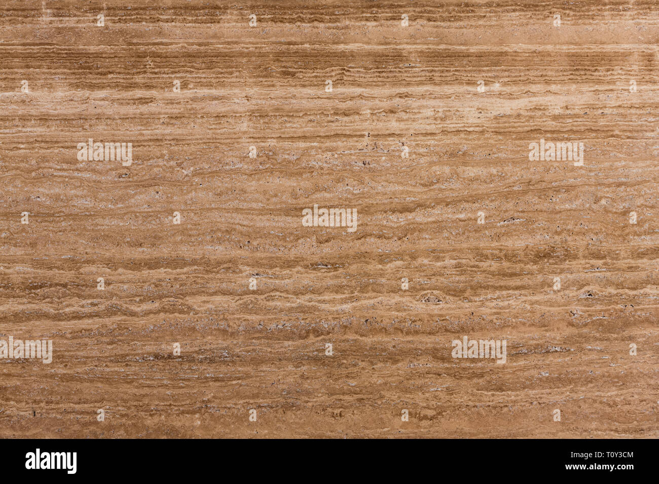 Travertine gold. Pattern of natural origin on the surface of the stone, close-up.  Stock Photo