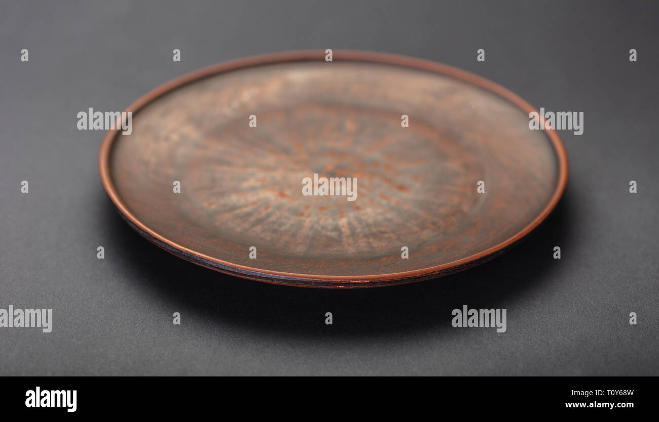 new clay plate closeup on black background Stock Photo
