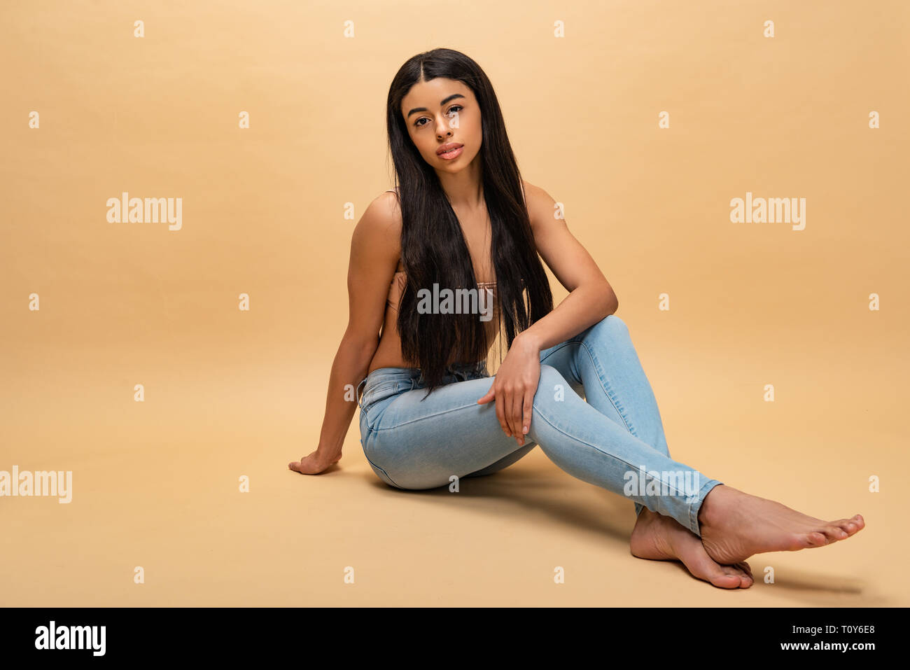 pretty african american woman sitting and looking at camera Stock Photo