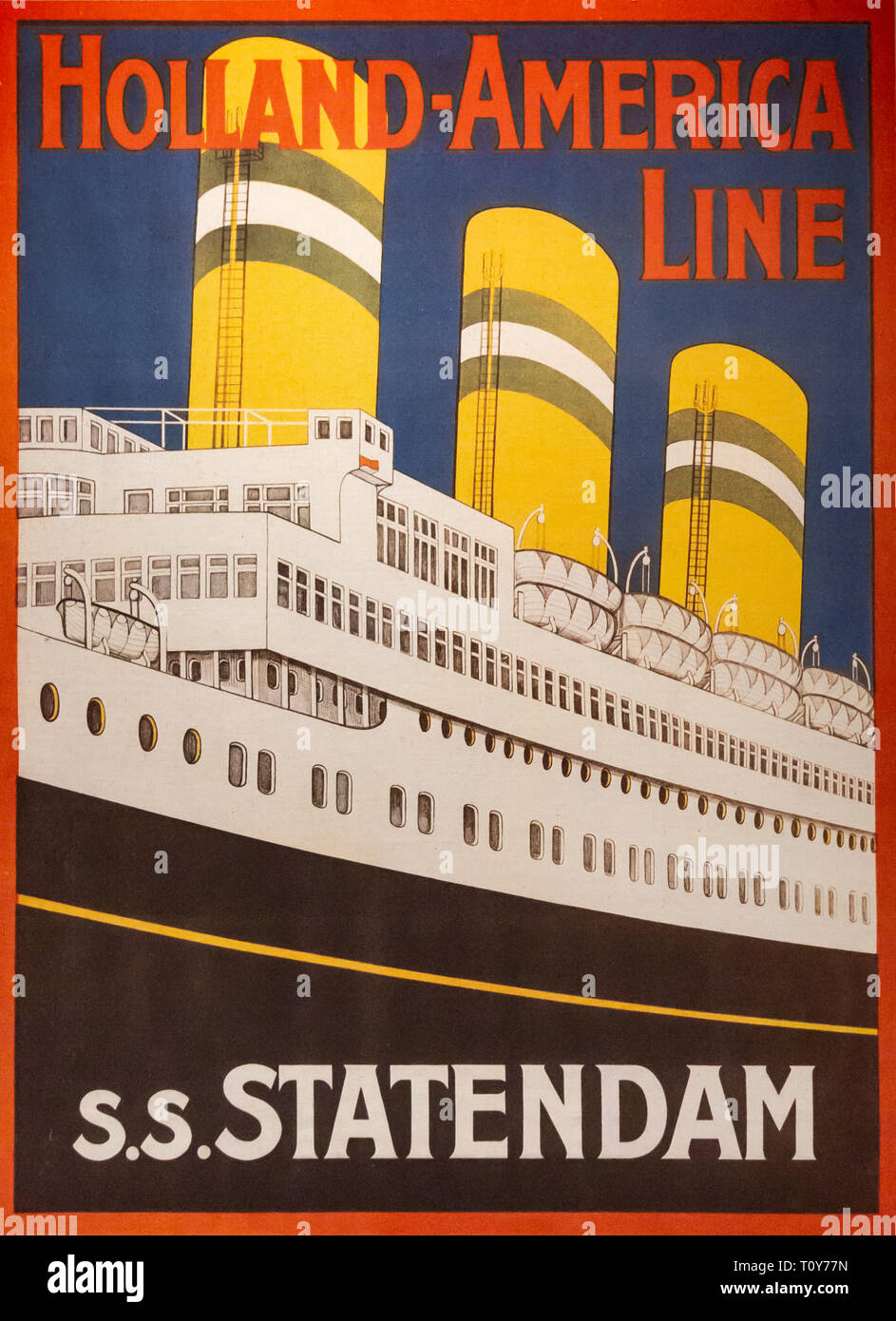 A travel poster for the Holland-America Line SS Statedam on the wall of the Immigration Museum on Ellis Island in New York City. Stock Photo