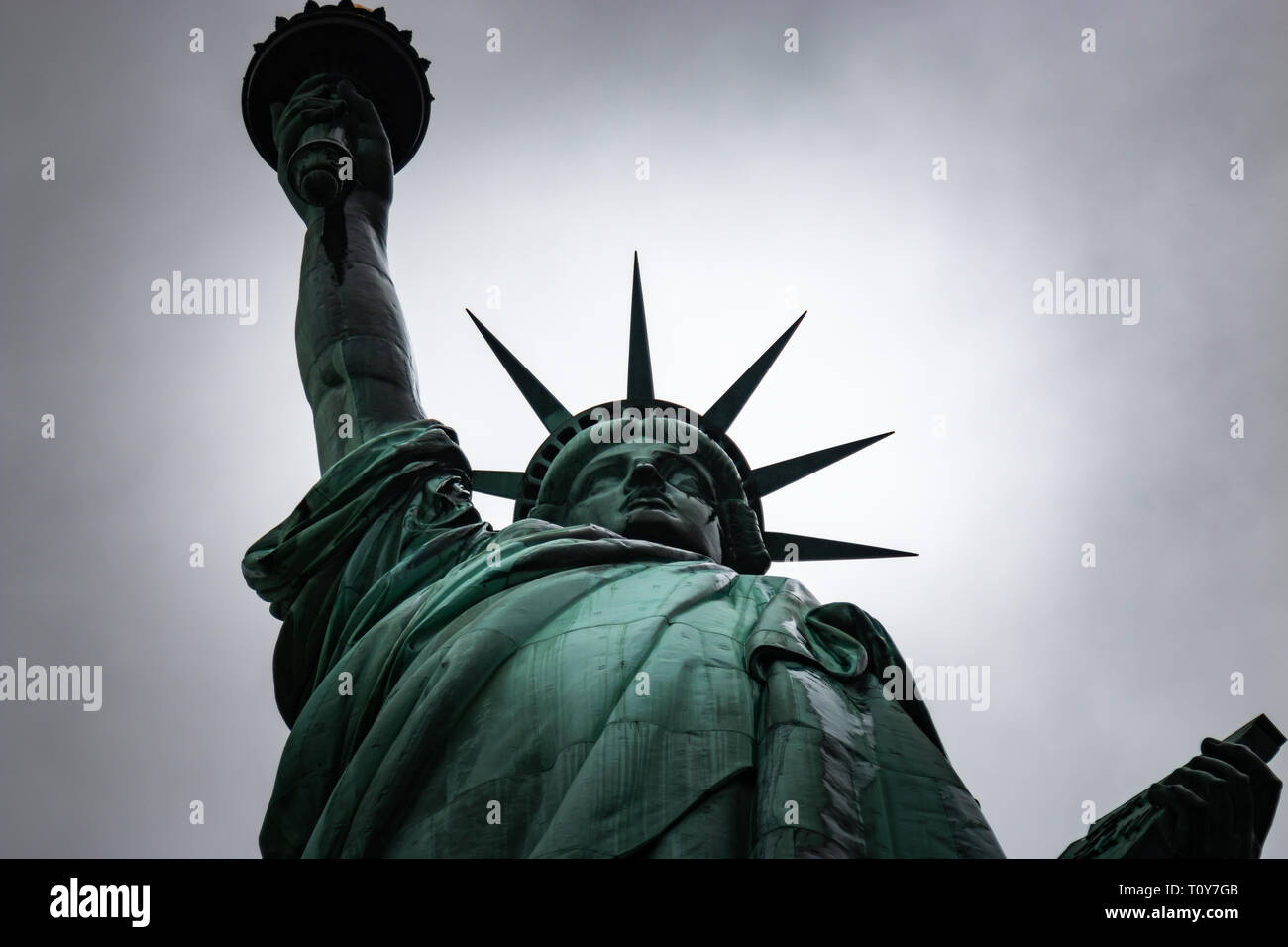 A close up of a rainwet Statue of Liberty focussing on her face, crown