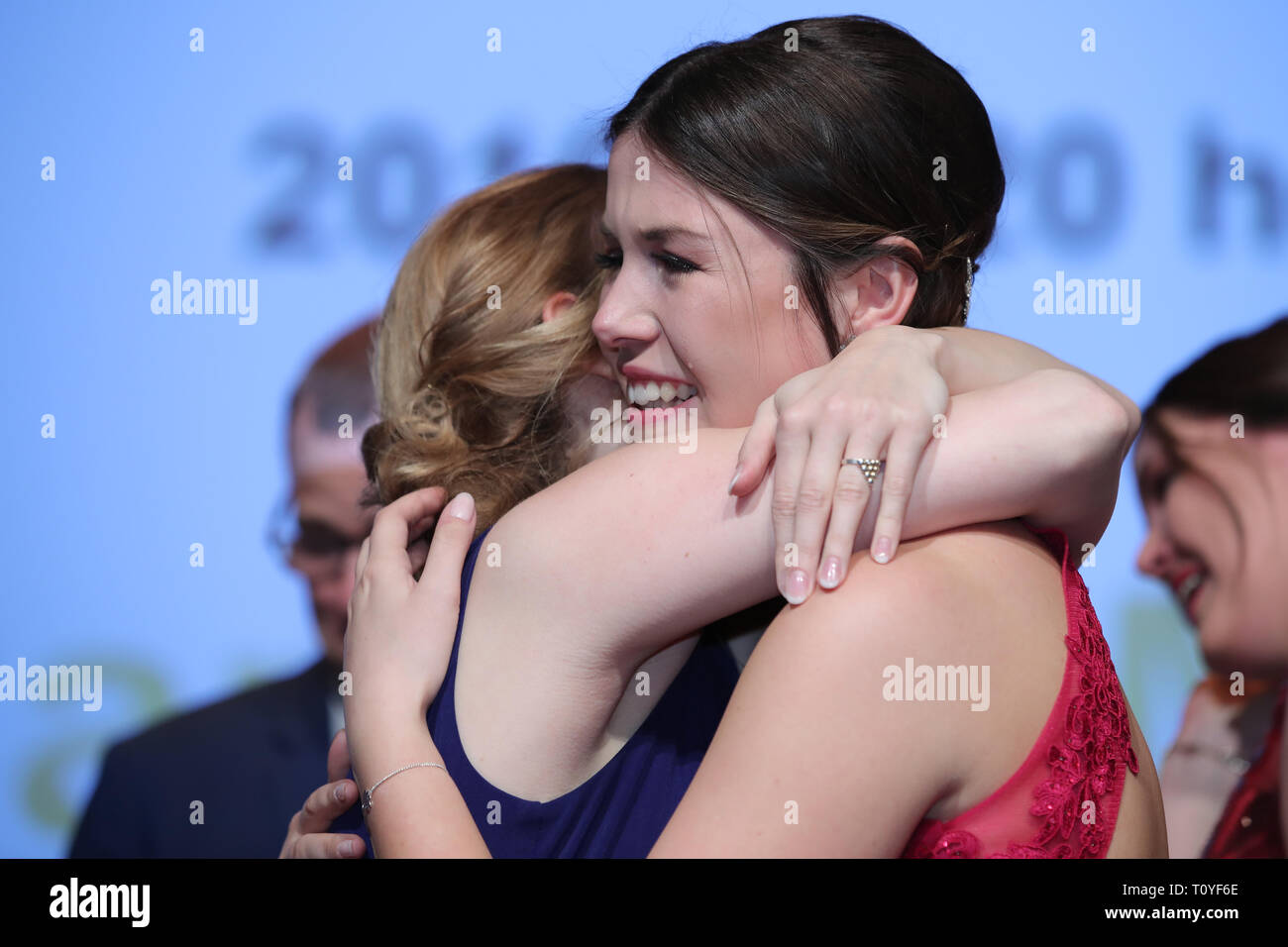 Grafenrheinfeld, Germany. 22nd Mar, 2019. The outgoing Franconian wine queen Klara Zehnder (l) embraces her newly elected successor Carolin Meyer (r) and congratulates her on her office. The 23-year-old winegrower Carolin Meyer from Castell-Greuth (district of Kitzingen) is the 64th Franconian Wine Queen. Credit: Daniel Karmann/dpa/Alamy Live News Stock Photo