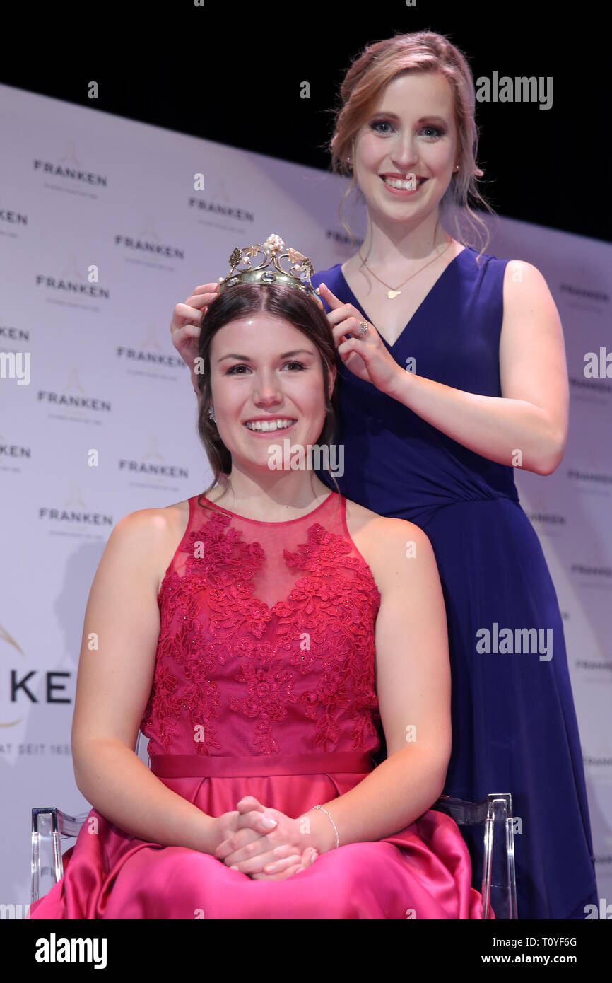 Grafenrheinfeld, Germany. 22nd Mar, 2019. The outgoing Franconian wine queen Klara Zehnder puts the crown of the Franconian wine queen on her newly elected successor Carolin Meyer. The 23-year-old winegrower Carolin Meyer from Castell-Greuth (district of Kitzingen) is the 64th Franconian Wine Queen. Credit: Daniel Karmann/dpa/Alamy Live News Stock Photo