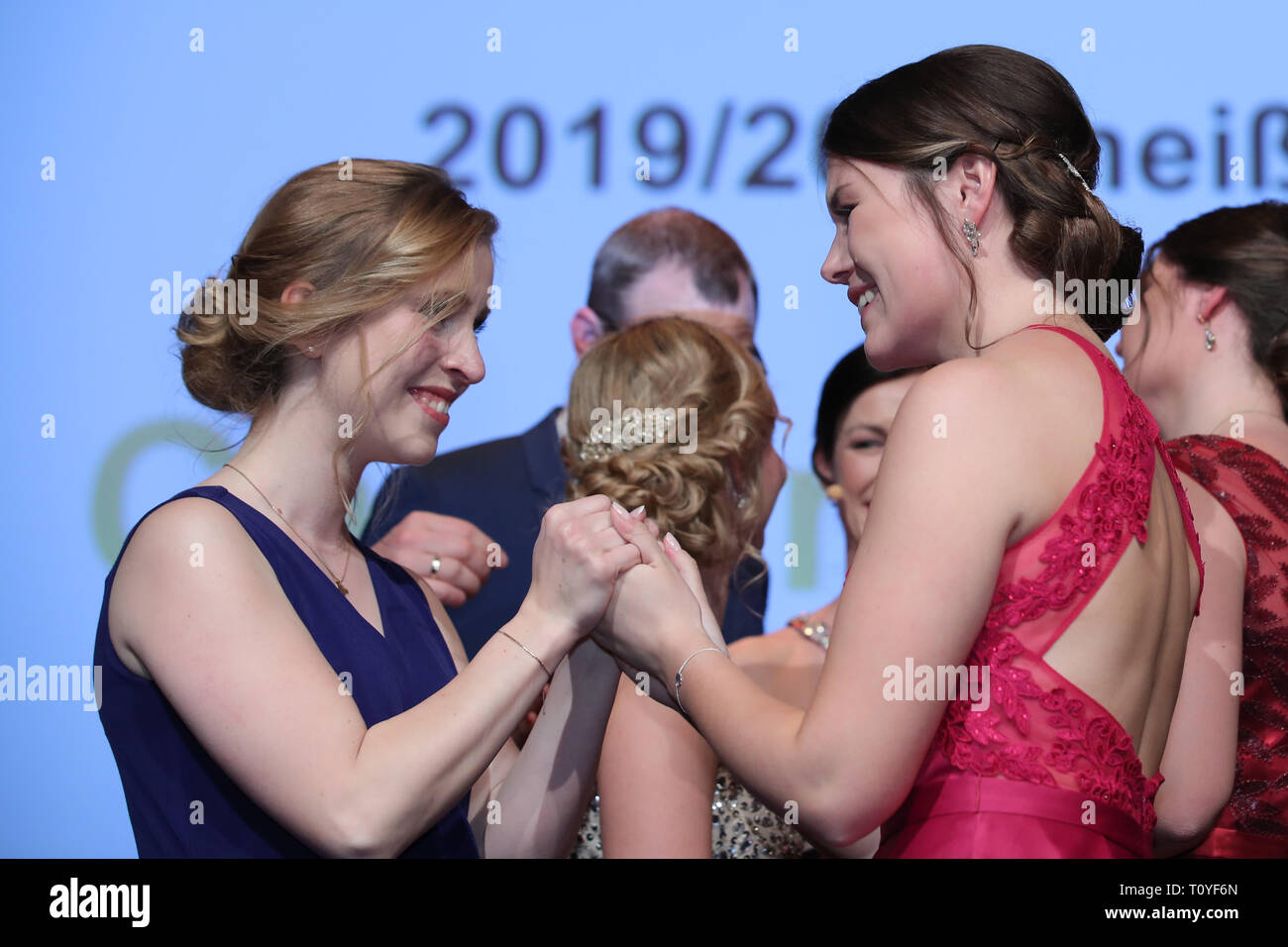 Grafenrheinfeld, Germany. 22nd Mar, 2019. The outgoing Franconian wine queen Klara Zehnder (l) congratulates her newly elected successor Carolin Meyer (r) on her office. The 23-year-old winegrower Carolin Meyer from Castell-Greuth (district of Kitzingen) is the 64th Franconian Wine Queen. Credit: Daniel Karmann/dpa/Alamy Live News Stock Photo