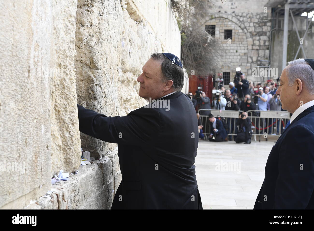 U.S. Secretary of State Mike Pompeo, left, leaves a prayer at the Western Wall as Israeli Prime Minister Benjamin Netanyahu, right, looks on March 21, 2019 in Jerusalem, Israel. Stock Photo