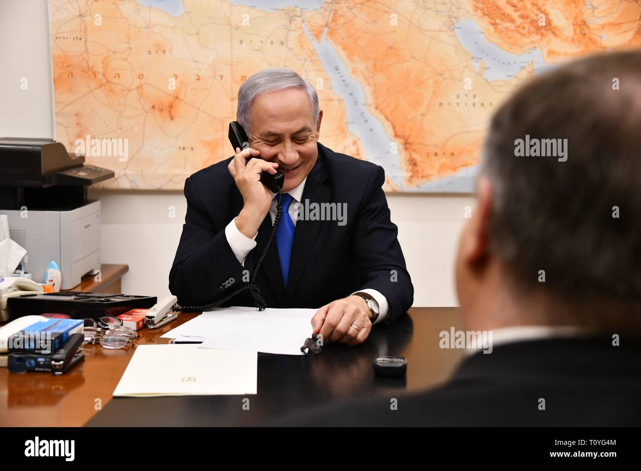 Israeli Prime Minister Benjamin Netanyahu smiles as he speaks by phone with U.S. President Donald Trump from his office March 21, 2019 in Jerusalem, Israel. Trump surprised Netanyahu telling him the U.S. will recognize Israeli sovereignty over the occupied Golan Heights, which it captured from Syria in 1967. Stock Photo