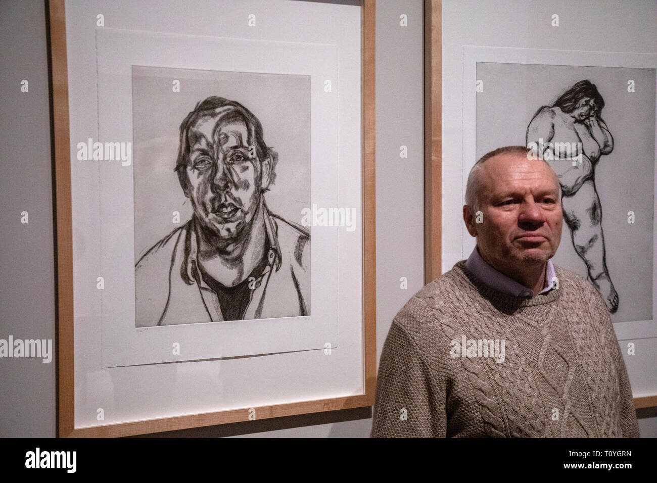 Moscow, Russia. 22nd Mar 2019/ Visitor takes pictures on the background of the painting 'David Dawson' of Lucian Freud in the Pushkin State Museum of Fine Arts during the exhibition “Francis Bacon, Lucian Freud, and the School of London.” in Moscow, Russia. The artworks provided by the Tate Gallery, London. Stock Photo