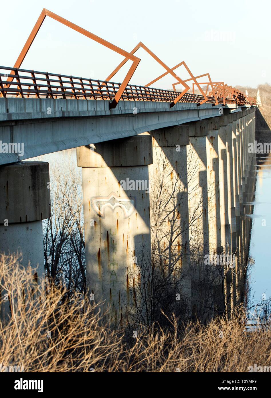 Madrid, Iowa, USA. 22nd Mar, 2019. Originally a conduit for rail freight, but now a decomissioned railroad line, the High Trestle Trail Bridge is part of the 25-mile Trestle Trail path for bikers, hikers and horseback riders. The artistic, spiral steel frames springing up from the road bed are a nod to the shape of the timbers placed in former central Iowa coal mines. Credit: Brian Cahn/ZUMA Wire/Alamy Live News Stock Photo