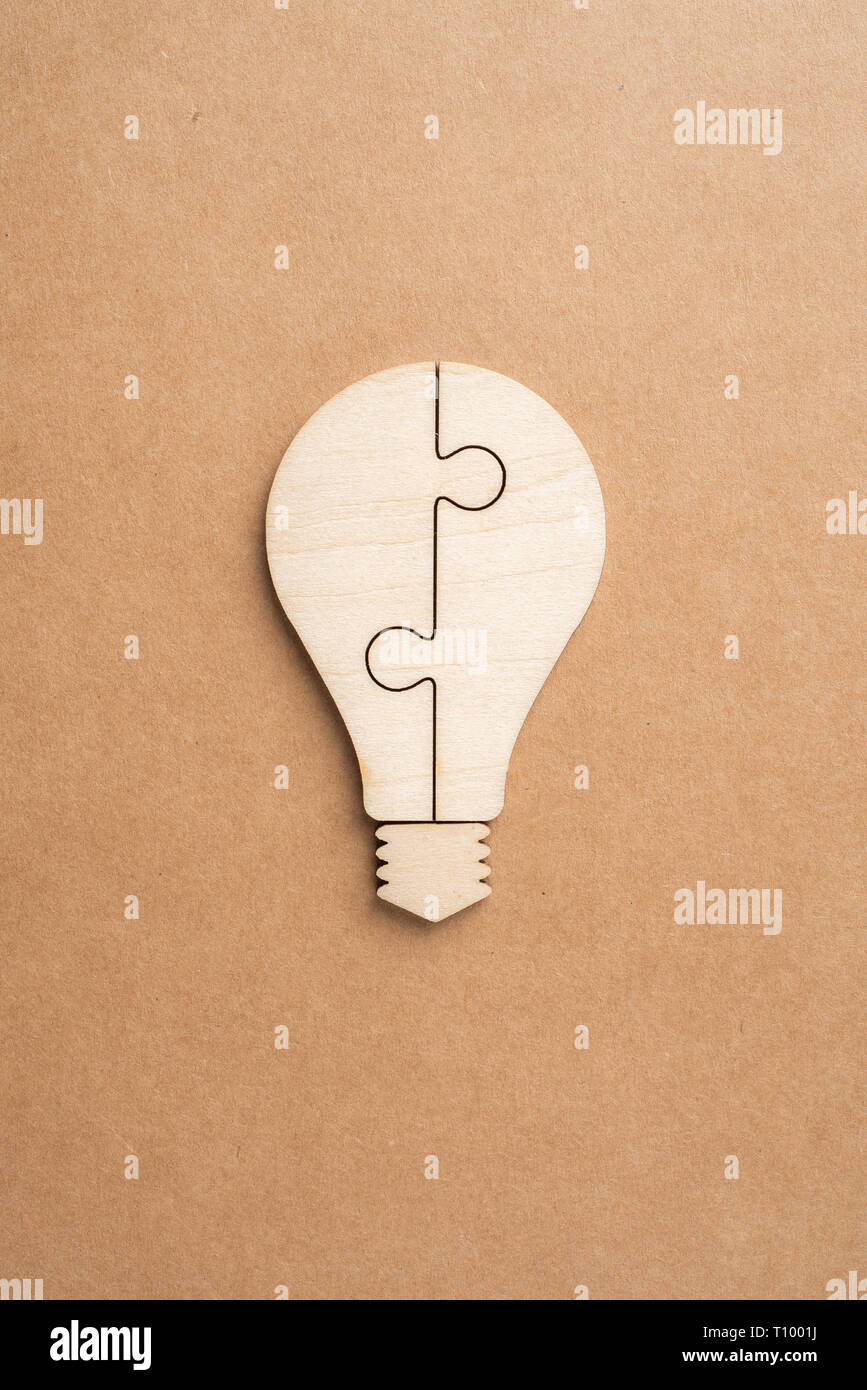 Business and design concept - light bulb jigsaw icon on kraft paper. it's conversation, leadership concept Stock Photo