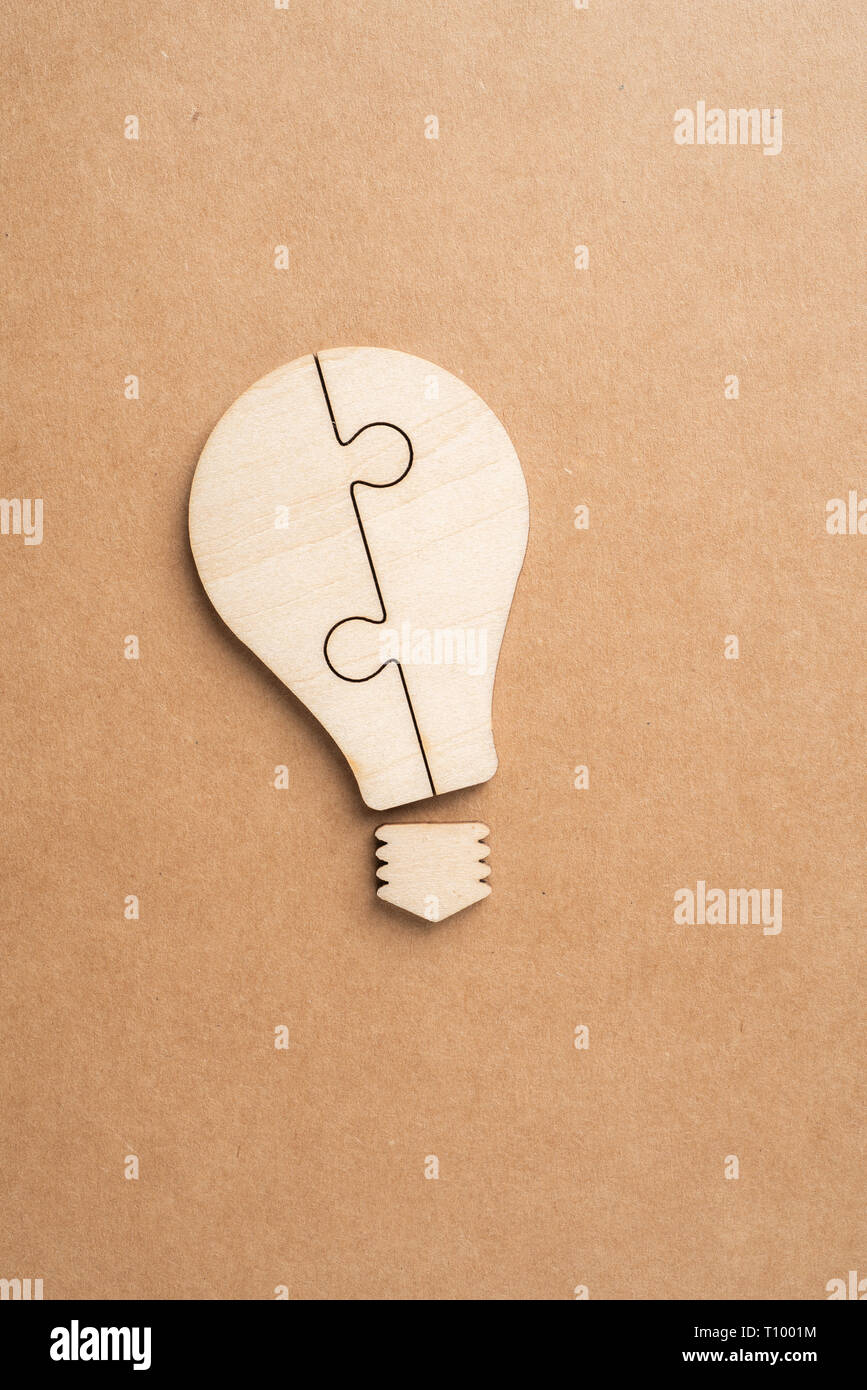 Business and design concept - light bulb jigsaw icon on kraft paper. it's conversation, leadership concept Stock Photo