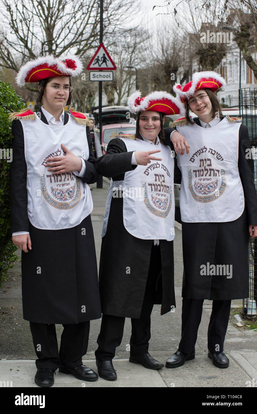 Hasidic boys young men in fancy dress in Stamford Hill dance and sing collecting for charity on the Jewish holiday of Purim Stock Photo