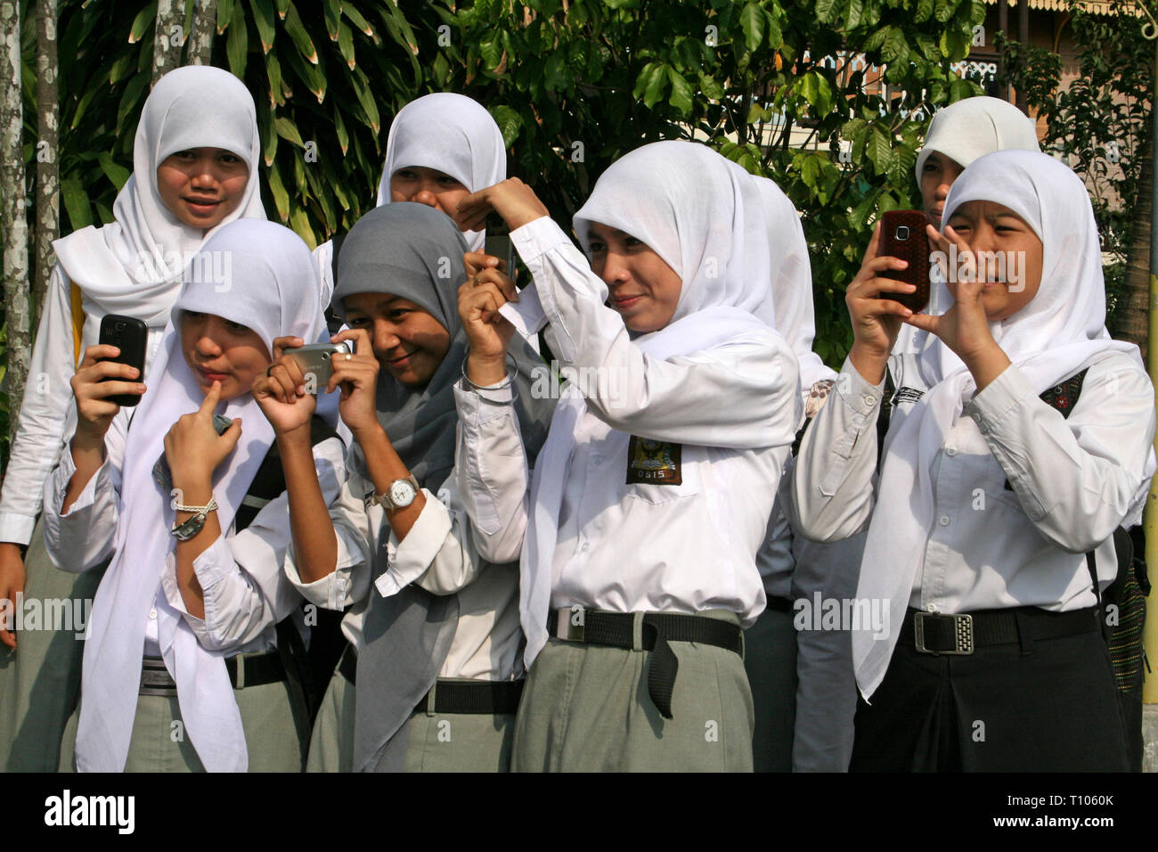 Muslim Girls Taking Photos In Medan, Sumatra Stock Photo