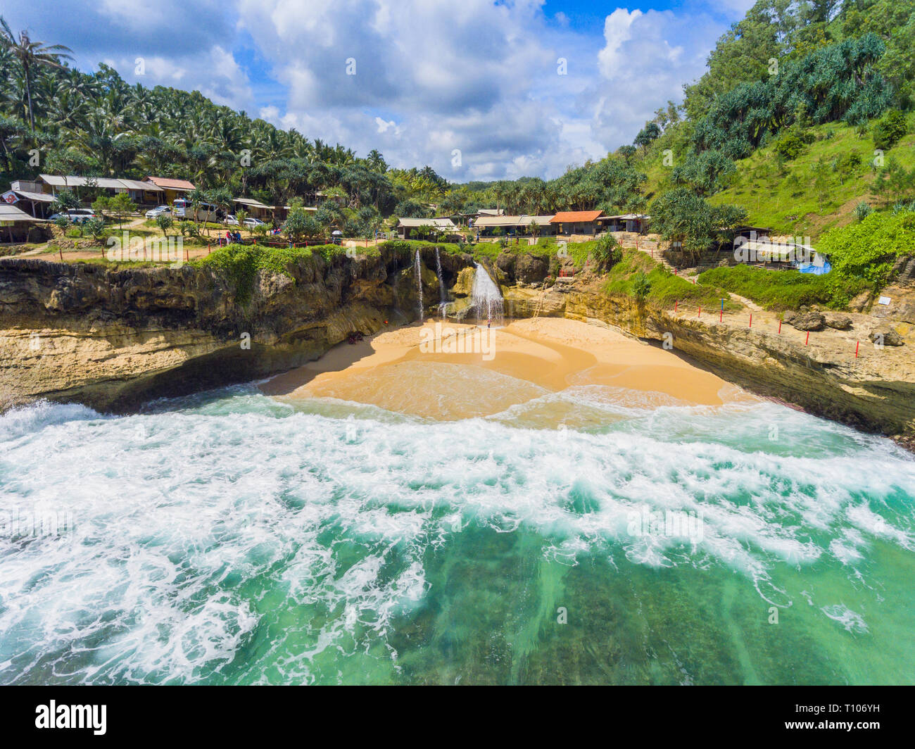 When freshwater meet salt water. A small waterfall, Banyu Tibo plunge into the sea in East Java Stock Photo