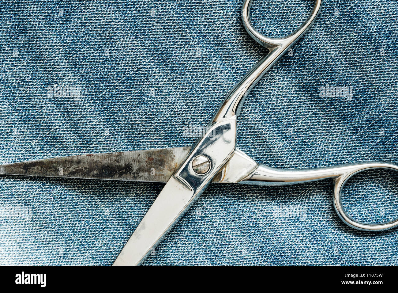 Metal scissors laying on the jeans background Stock Photo Alamy