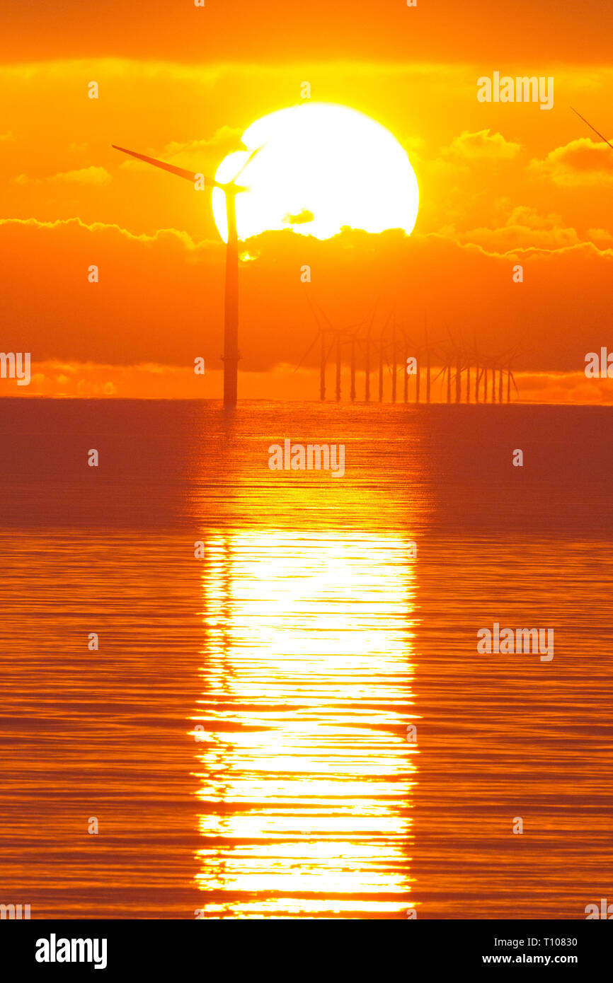 Dawn over off shore Wind turbine farm .Part of Governments policy of providing a higher percentage of wind power by the 1930's . Stock Photo