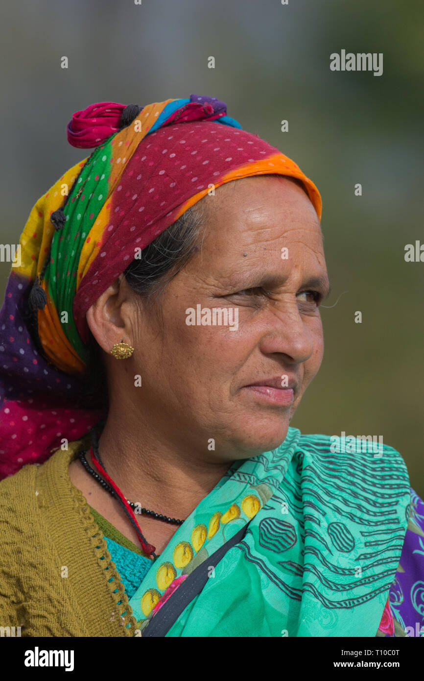 Woman wearing dyed wax resist headwear in three colours. Red bindi mark on the forehead. Rudraprayag-Ukhimath, Chopta, Triyuginarayan area, Lower Himalayas, Northern India. Stock Photo