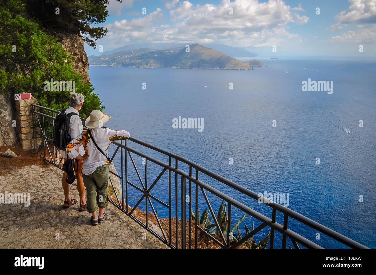 Couple of tourists watching the view from a terrace of Capri, Capri Island, Italy Stock Photo