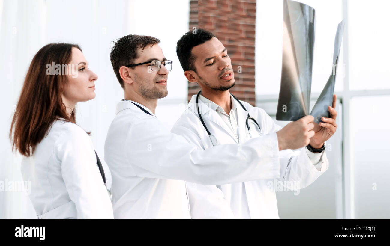 Group of doctors and nurses looking at X-ray Stock Photo