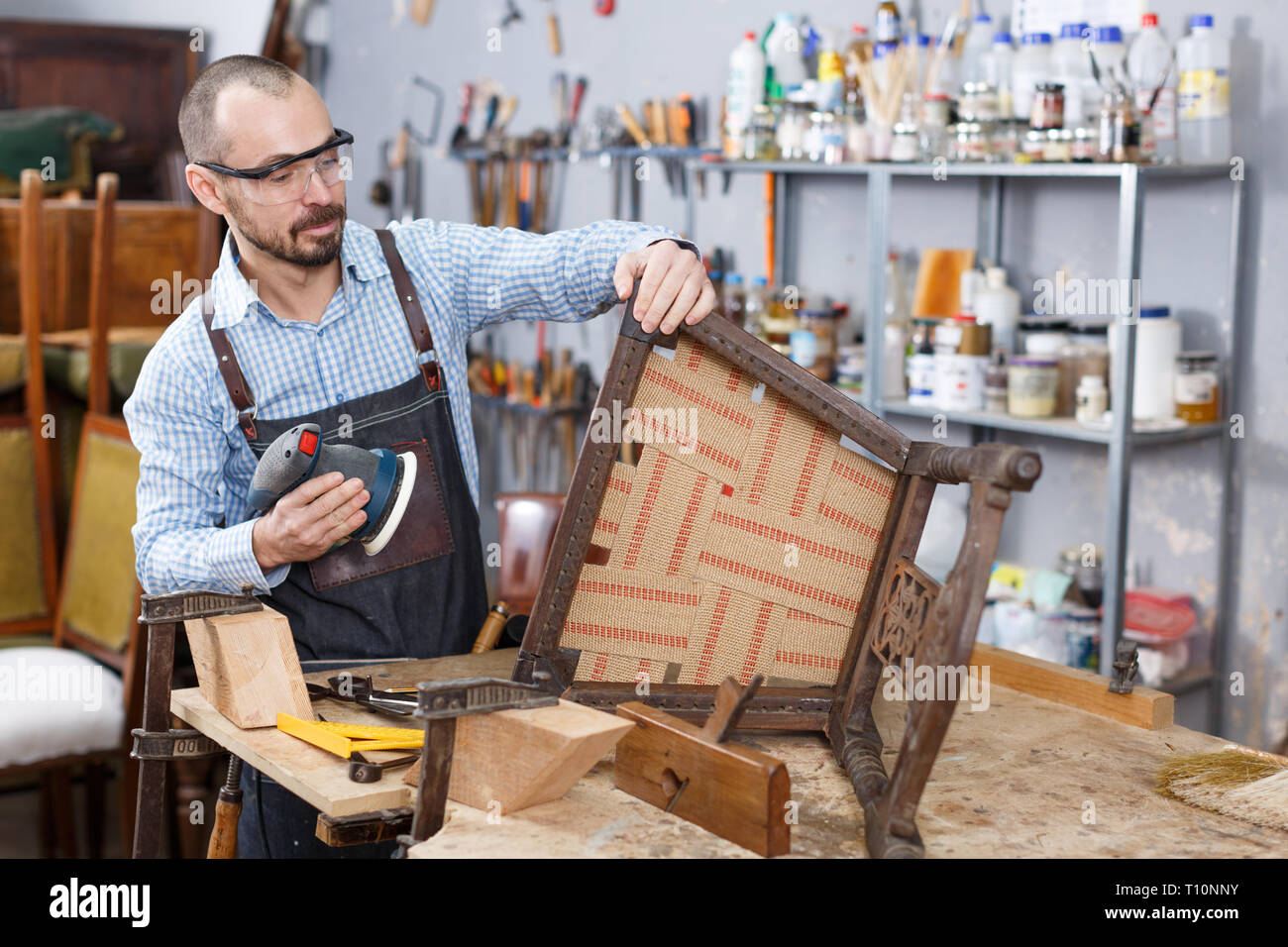 Cheerful craftsman with carpentry tools posing in furniture restoration studio Stock Photo Alamy