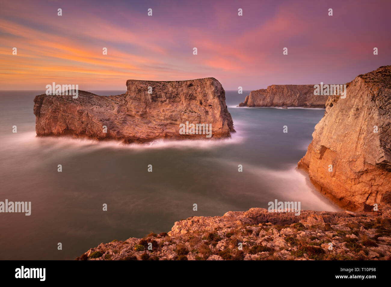 Sunset sky dramatic Algarve coast rock stacks on the near Cape St Vincent Costa Vicentina Sagres Portugal coast Algarve,Portugal EU Europe Stock Photo