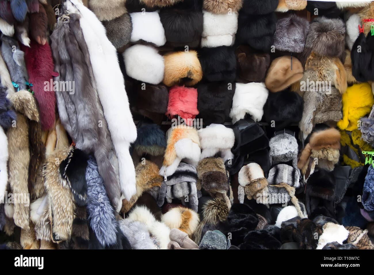 Natural fur and hats are sold on the market. Fur products. Stock Photo