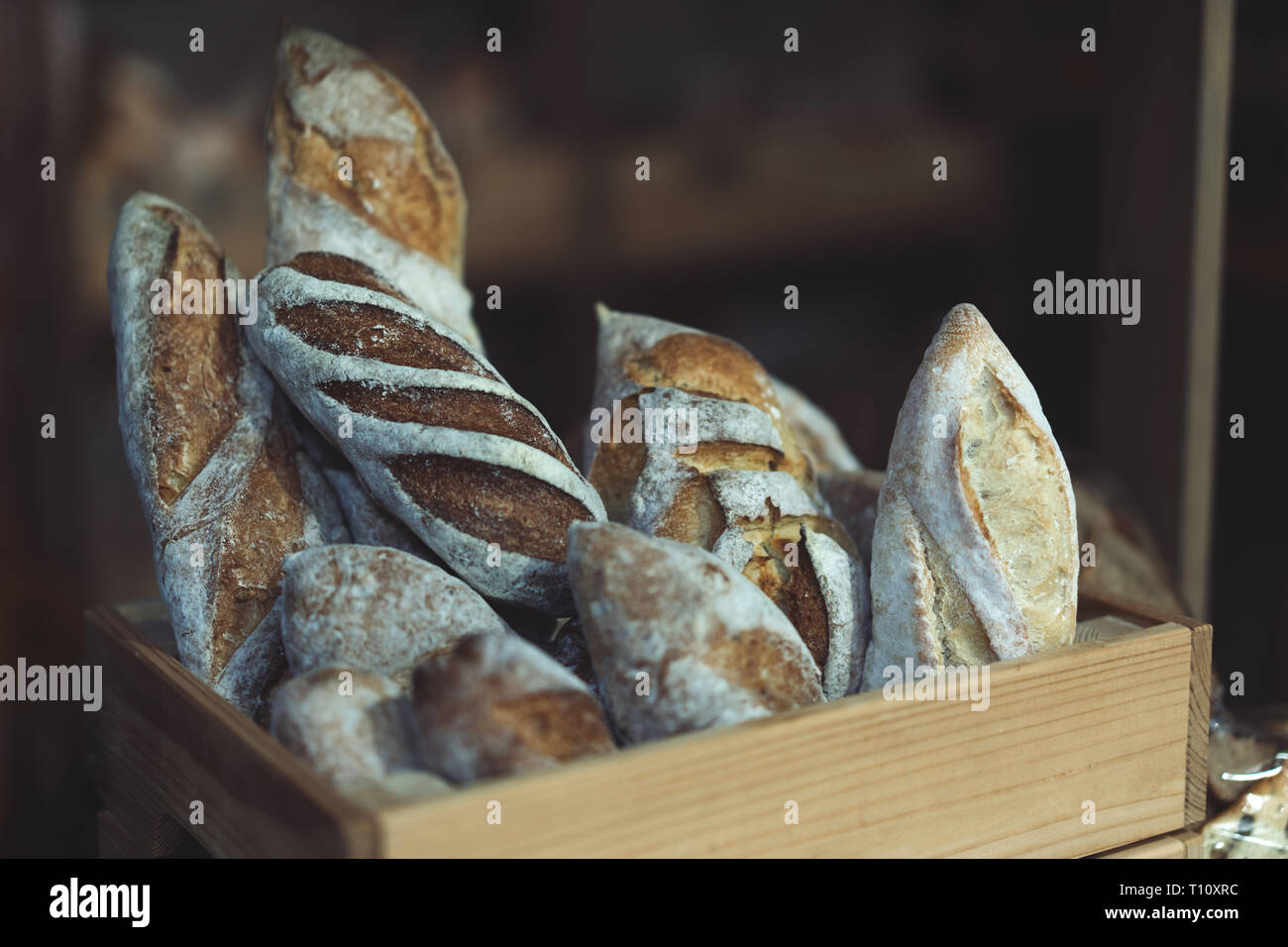 https://c8.alamy.com/comp/T10XRC/bread-loaves-large-and-small-in-a-wooden-box-on-the-counter-in-a-bakery-shop-fresh-pastries-and-flour-products-T10XRC.jpg