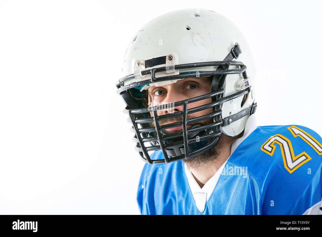 Composite image of portrait of rugby player wearing shoulder pads and  holding helmet Stock Photo - Alamy