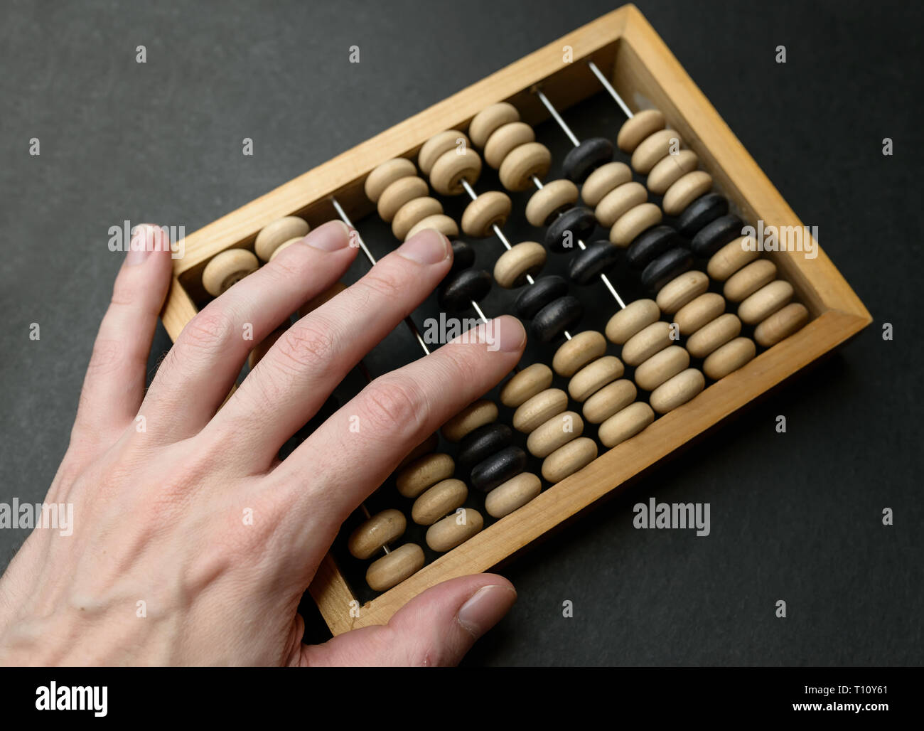 Old wooden abacus on dark background. Stock Photo