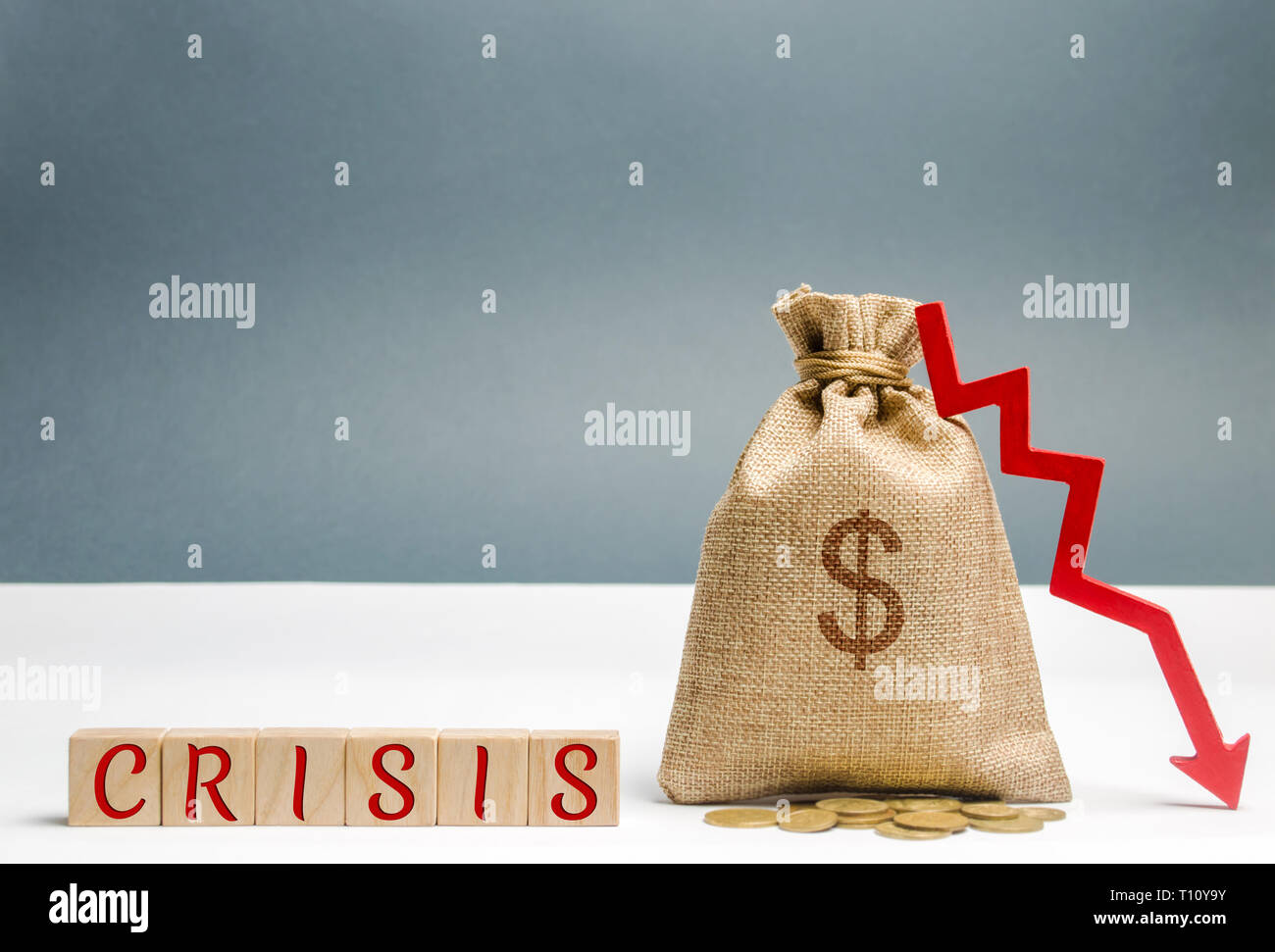 Wooden blocks with the word Crisis and money bag. The concept of financial and economic crisis. capital outflow. sabotage of the economy. bankruptcy.  Stock Photo