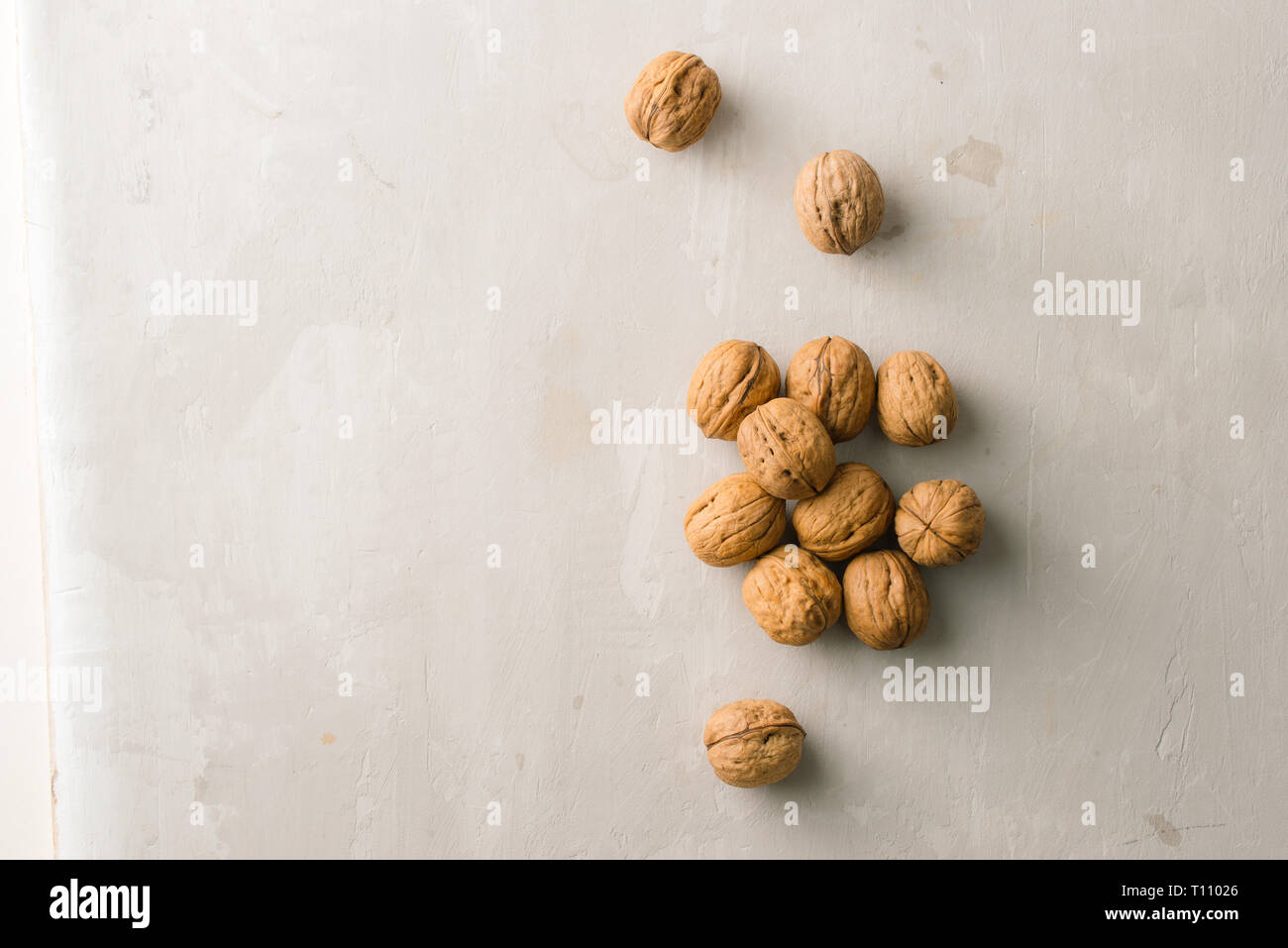 Whole organic walnuts on gray stone table Stock Photo