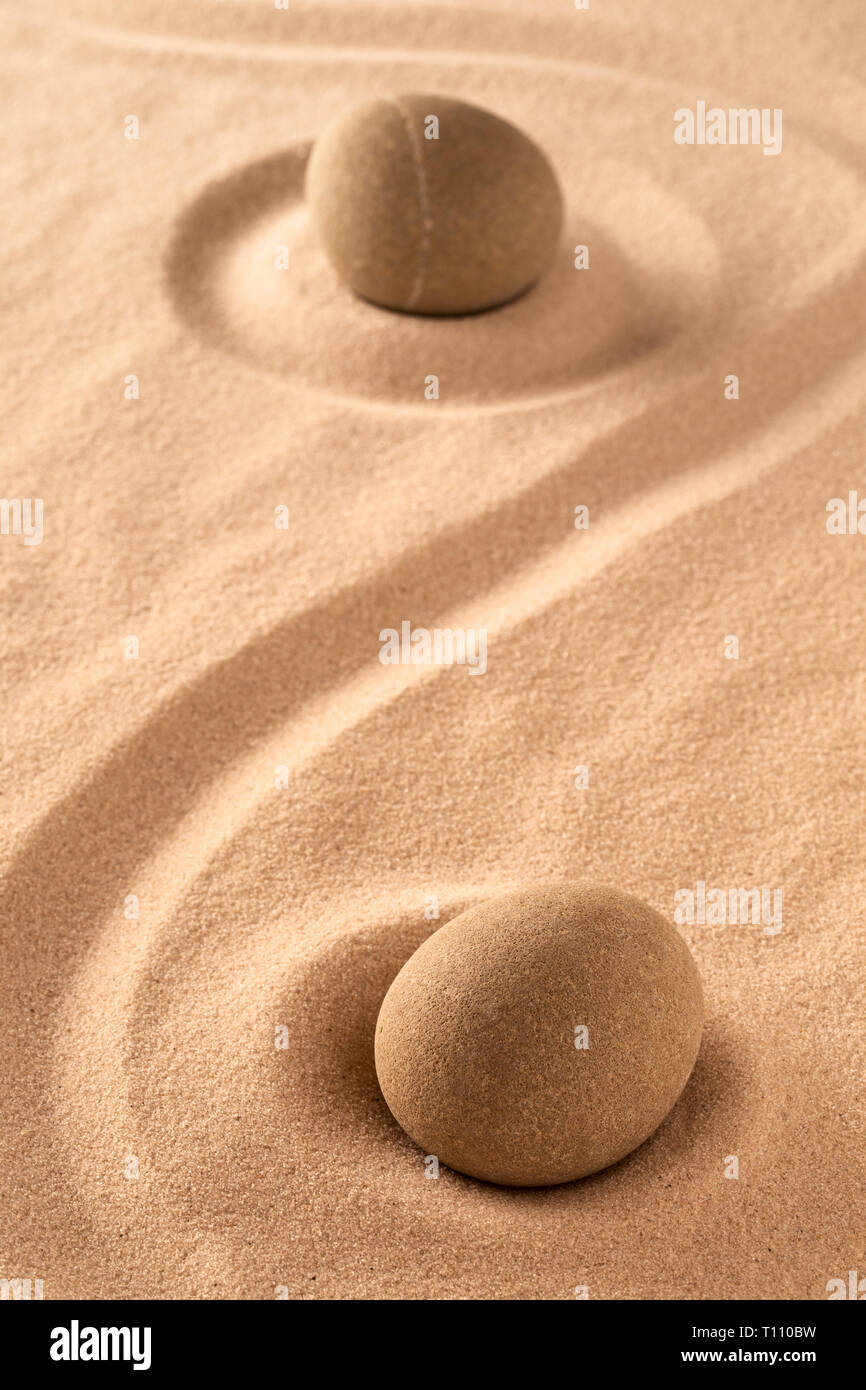 zen meditation stone in raked sand Stock Photo