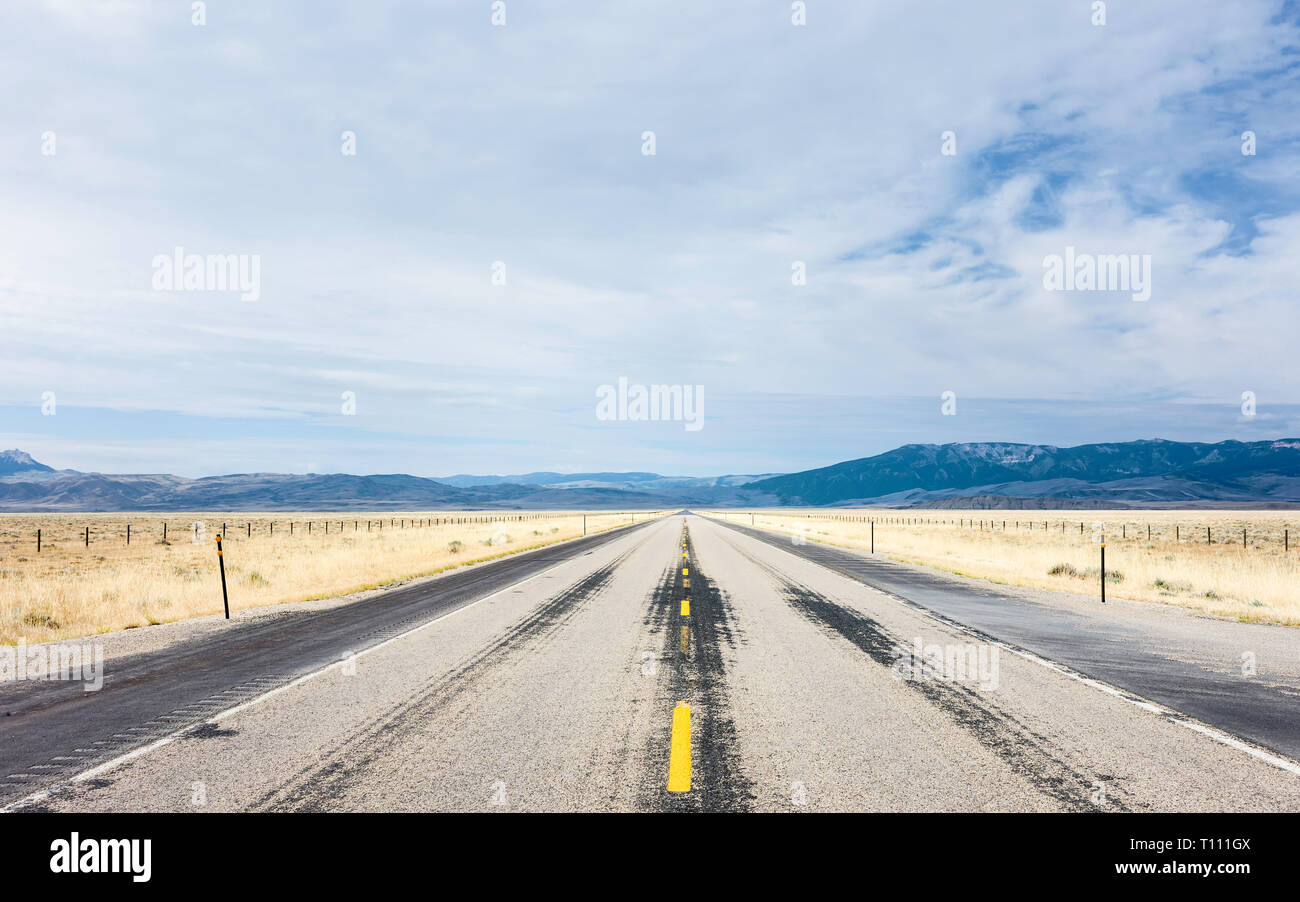 Interstate 90 flanked by prairie and the Rockies on a hot summer
