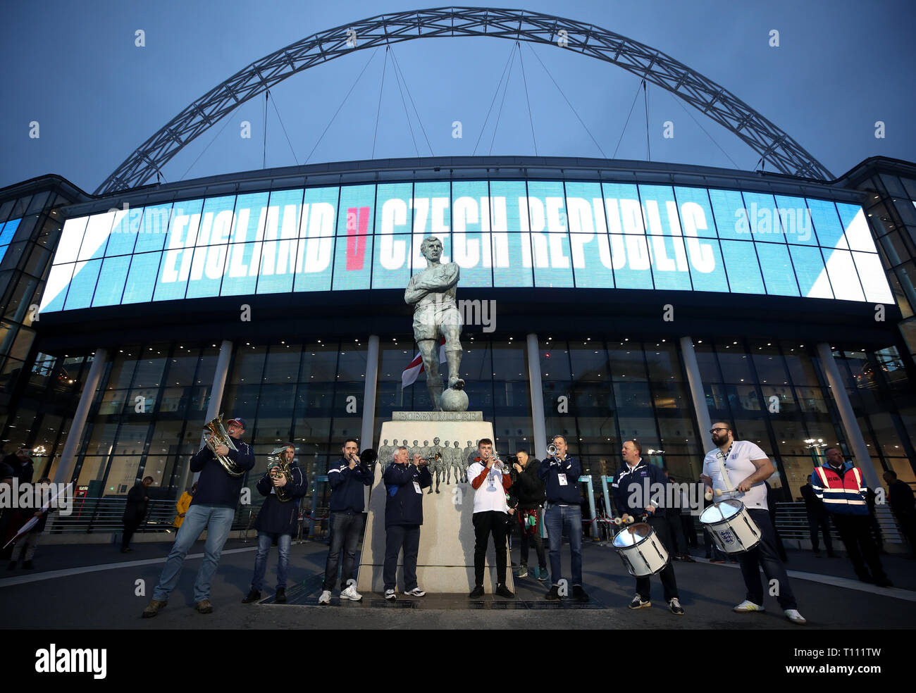 A band play in front of the Bobby Moore statue outside Wembley Stadium