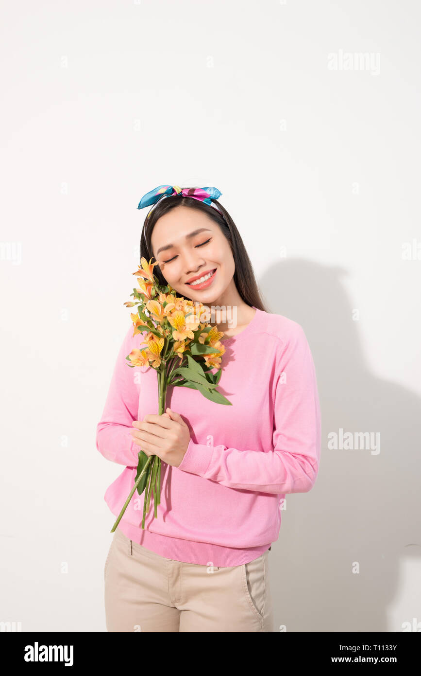 Lifestyle leisure international women's day concept. Close up portrait of lovely cute adorable excited delightful attractive woman holding flowers iso Stock Photo