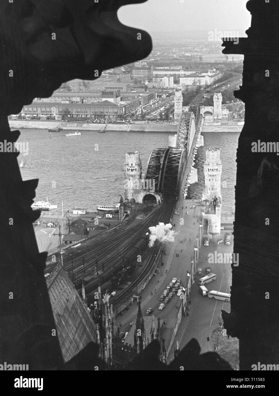Germany, cities and communities, Cologne, bridges, Hohenzollernbruecke (Hohenzollern Bridge), topview from a tower of the cathedral, 1957 city, people, river, rivers, Rhine, railroad bridge, railway bridge, road bridge, destruction, destructions, demolitions, war damage, portal, portals, transport, transportation, railway, railroad, railways, railroads, view to Deutz, Rhineland, North Rhine-Westphalia, Germany, Europe, 20th century, 1950s, bridges, bridge, topview, top view, topviews, top views, tower, towers, cathedral, cathedrals, historic, his, Additional-Rights-Clearance-Info-Not-Available Stock Photo