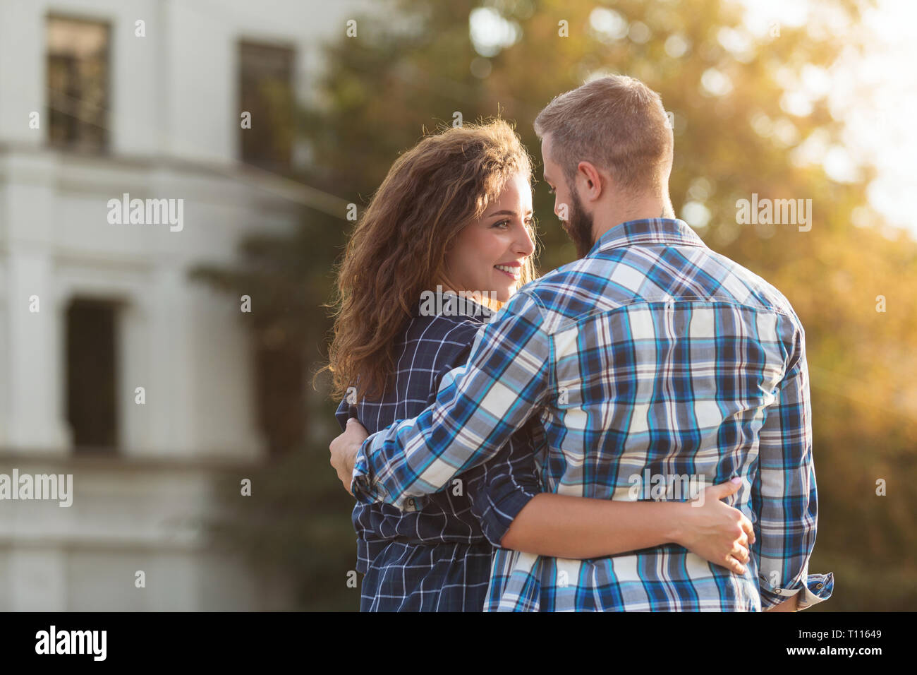 Romantic couple walking and hugging in the city Stock Photo - Alamy