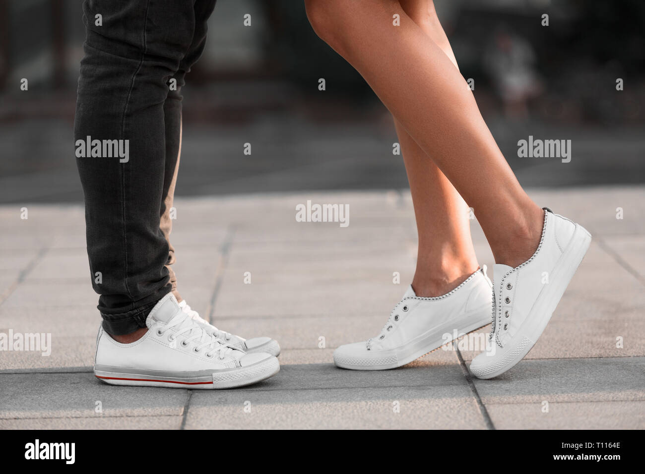 Male and female legs during date, couple kissing in city Stock Photo