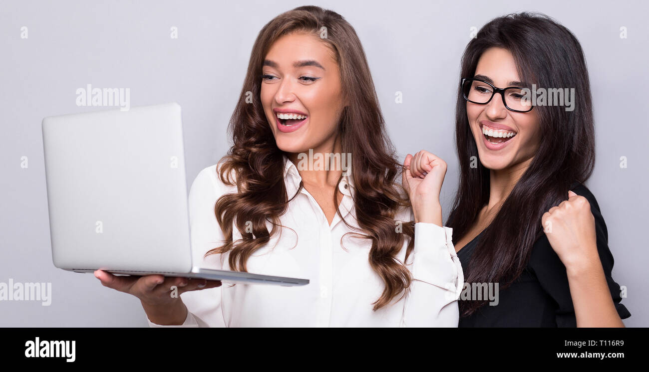 Happy business women working together on laptop Stock Photo