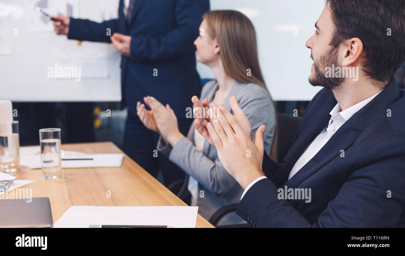 Business colleagues applauding to reporter at seminar Stock Photo