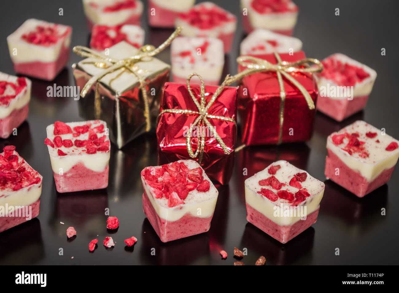 Festive Christmas background with chocolate and small Christmas decoration box gift. Stock Photo