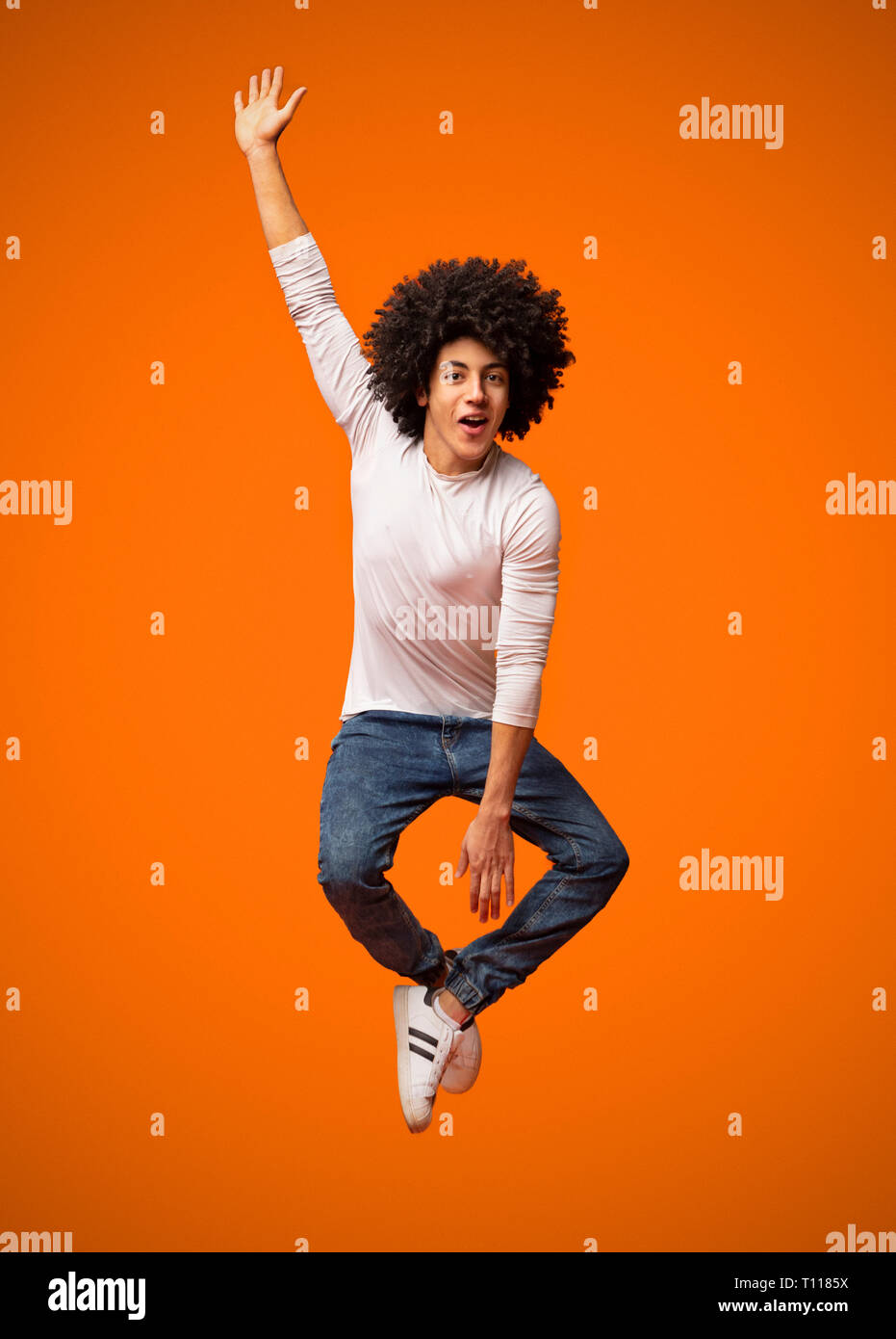 Funny young black man jumping on the air Stock Photo