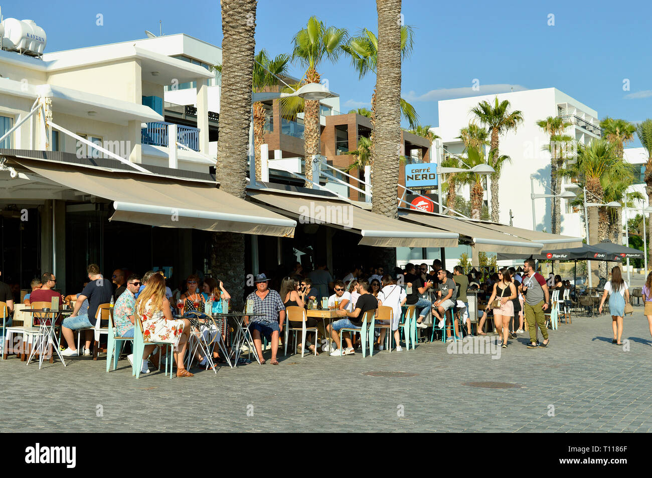 Tourists eating and drinking in Paphos harbour, Cyprus Stock Photo Alamy