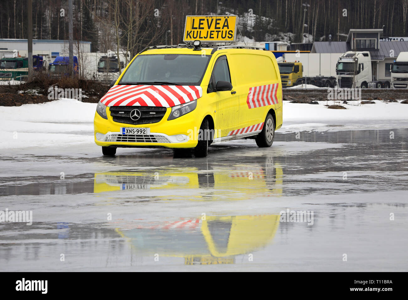 Forssa, Finland - March 16, 2019: Mercedes-Benz Sprinter pilot vehicle parked on icy yard. Pilot or escort vehicles escort trucks with oversize loads. Stock Photo