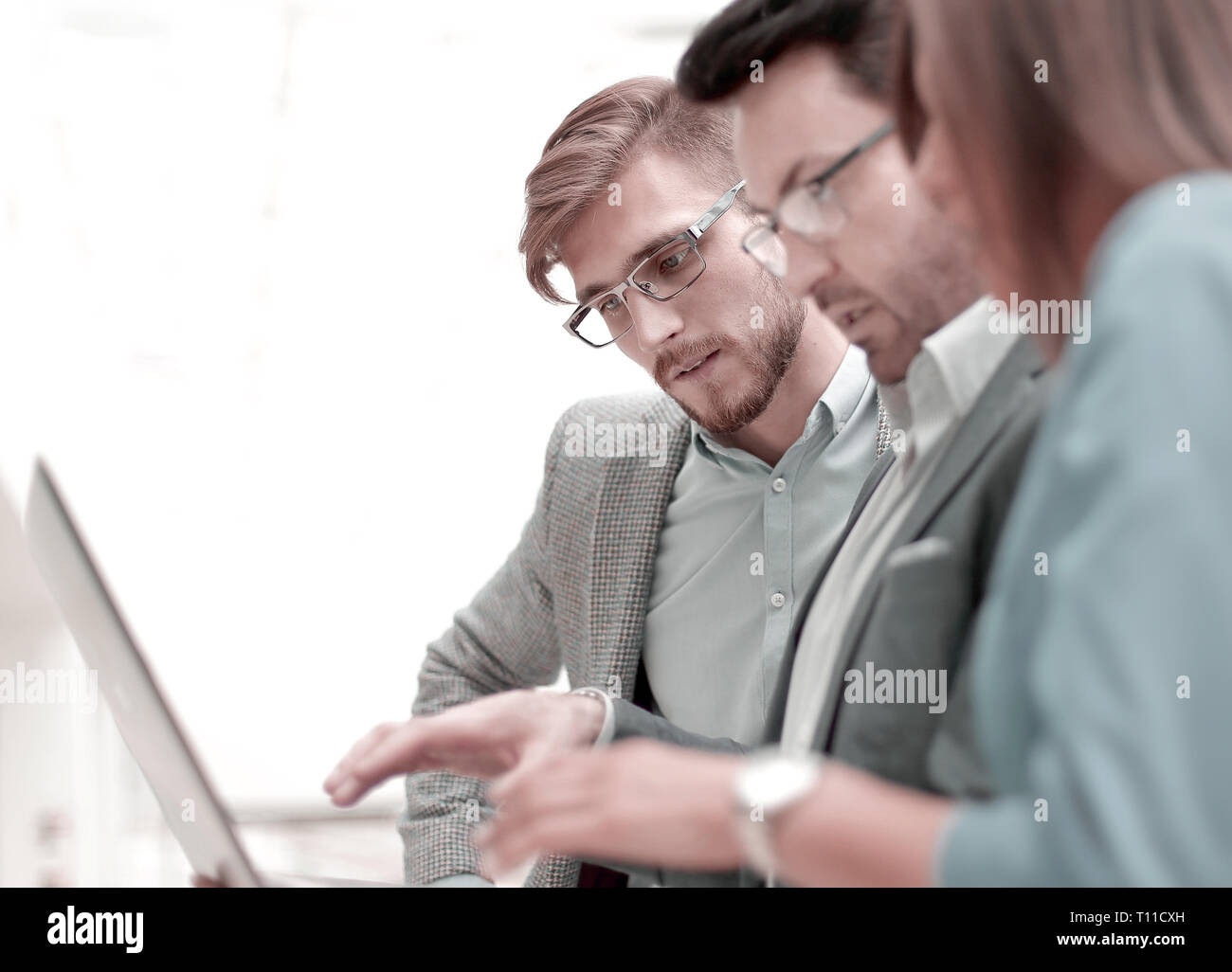 close up.three employees using a laptop. Stock Photo